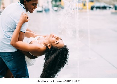 Couple spending romantic time at the fountain in city square