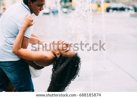 Couple spending romantic time at the fountain in city square