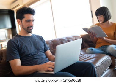 Couple spending time together while staying at home. - Shutterstock ID 1940605528