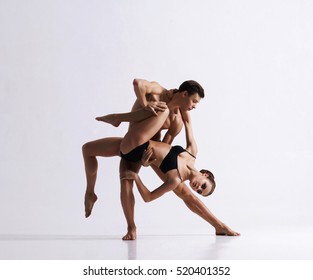 Couple of sporty ballet dancers in art performance