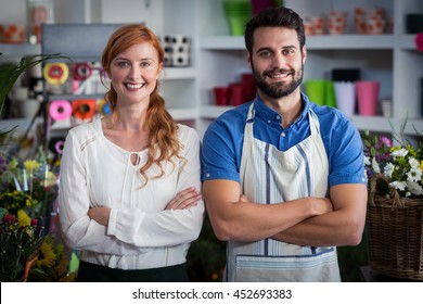 Couple standing with arms crossed in the flower shop - Powered by Shutterstock