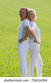Couple standing back to back