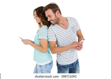 Couple Standing Back To Back And Man Looking At Womans Mobile Phone On White Background