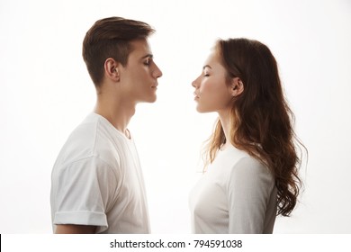 Couple Standing Face To Face With Their Eyes Closed. Boyfriend And Girlfriend Imagine Their Future Together. There Is Only One Mismatch. She Sees Cat And He Is More Like A Dog Person.