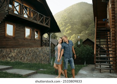 A couple standing in front of a house with a staircase. The woman is wearing a striped dress and the man is wearing a plaid shirt - Powered by Shutterstock