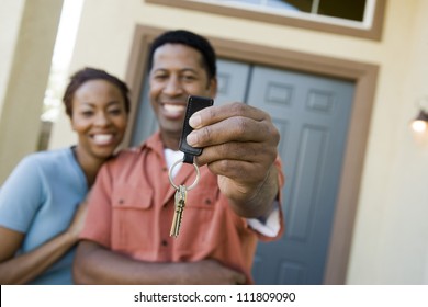 Couple Standing In Front Of A New House