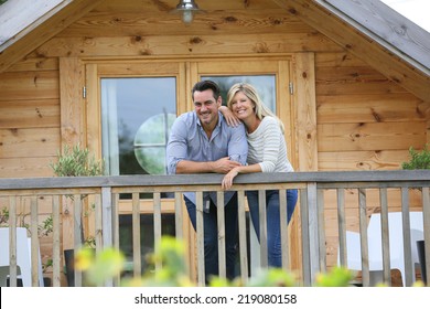 Couple Standing In Log Cabin Terrace 