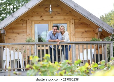 Couple Standing In Log Cabin Terrace 