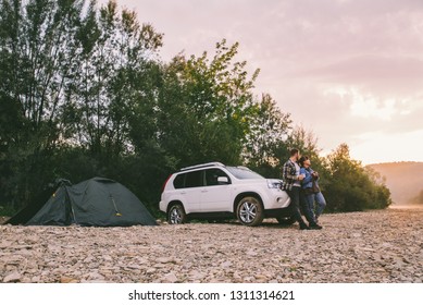 Couple Standing Looking On Sunrise And Drinking Tea. Car Camping. Lifestyle Concept