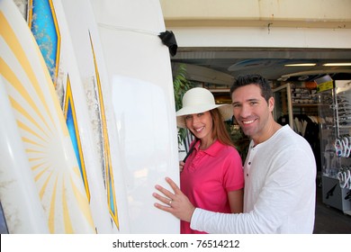 Couple Standing On A Surfshop