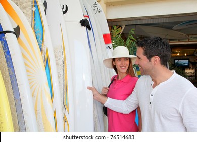 Couple Standing On A Surfshop