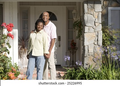 Couple Standing Outside Their House