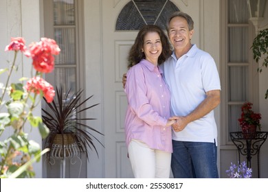 Couple Standing Outside Their House