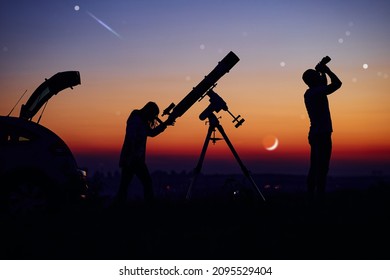 Couple Stargazing Together With A Astronomical Telescope.