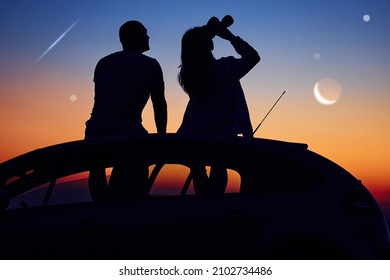 Couple Stargazing Together With A Astronomical Telescope.