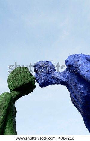 couple of statues giving a kiss in prague