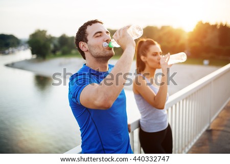 Couple staying hydrated after workout