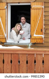 Couple Staying In Wooden Chalet