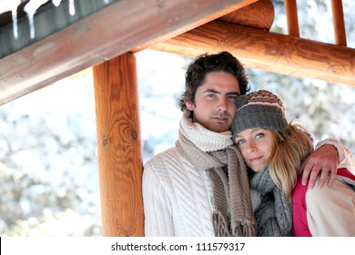 Couple Stood By Their Holiday Chalet