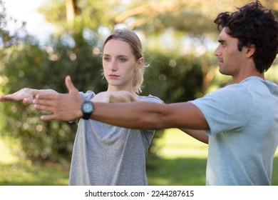 couple stretching in park young couple working exercise together - Shutterstock ID 2244287615