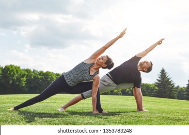 Couple stretching. Young couple stretching and doing yoga exercises in nature on a sunny morning. Healthy lifestyle concept - Powered by Shutterstock