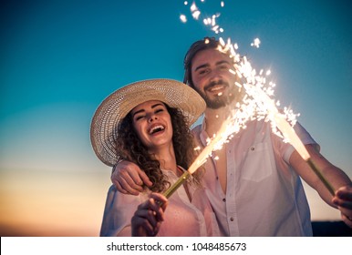 Couple strolling at the beach and smiling - Young adults enjoying summer holidays on a tropical island - Powered by Shutterstock