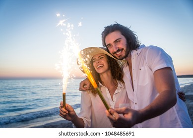 Couple strolling at the beach and smiling - Young adults enjoying summer holidays on a tropical island - Powered by Shutterstock