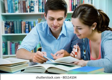 Couple Of Students In A Library