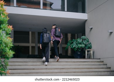 A Couple Students Using Black Backpack Walk Up The Stairs To Enter The Building