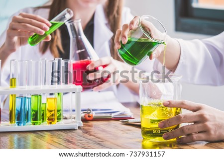 Couple of students working at chemistry class. Education concept