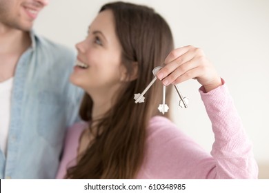 Couple Successfully Paid Off Real Estate Mortgage And Got Keys To Their Own Flat Or Apartment, Young Wife Showing House Keys, Looking At Her Husband With Excitement, Relocating Or Renting Property 