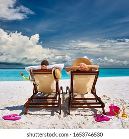 Couple in sun beds on a tropical beach at Maldives - Shutterstock ID 1653746530
