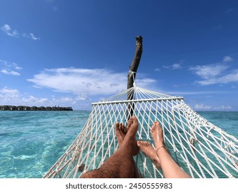 Couple sunbathing on the beach - Powered by Shutterstock