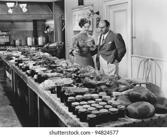 Couple With Table Covered In Food For Holiday Meal