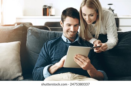 Couple, tablet and credit card on sofa for online shopping, bills or banking with fintech app in living room. Man, woman and digital touchscreen for e commerce, sale and deal with discount in home - Powered by Shutterstock