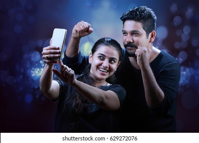 Couple Take A Selfie With A Mobile In The Night Celebration