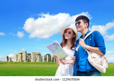 Couple Take World Map Adn Travel To Stonehenge