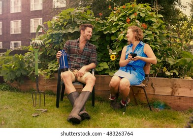 Couple Taking A Break On Council Estate Allotment