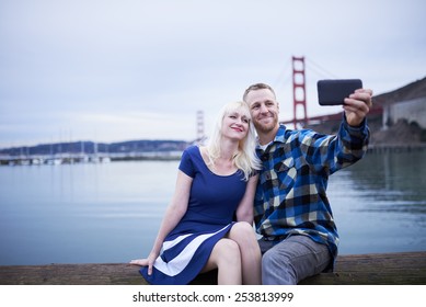 Couple Taking Romantic Selfie By Golden Gate Bridge With Copy Space