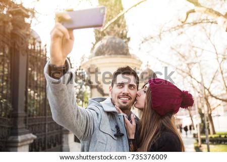 couple taking selfie in the street