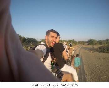 Couple Taking A Selfie In A Camel Riding In Desert - With Gopro Camera