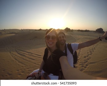 Couple Taking A Selfie In A Camel Riding In Desert - With Gopro Camera