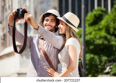 Couple taking a selfie with a camera - Powered by Shutterstock