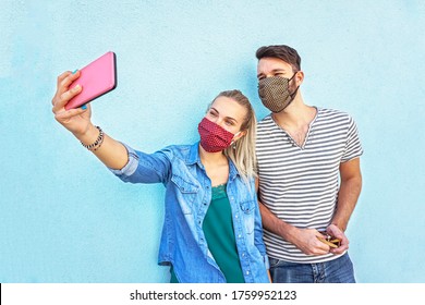 A couple taking selfie with face mask on for protection on corona virus time  - Powered by Shutterstock