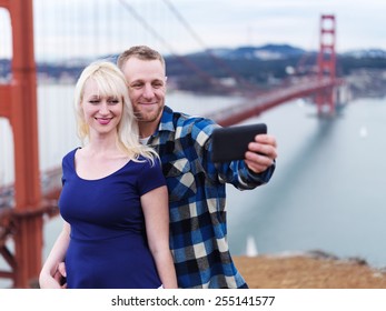 Couple Taking Selfie In Front Of Golden Gate Bridge At Battery Spencer