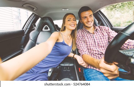 Couple Taking A Selfie Into A Sport Car While Driving