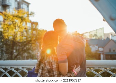 Couple Taking A Selfie On Bridge At Golden Hour