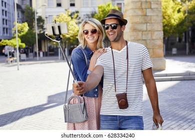 Couple Taking Selfie On City Break, Smiling