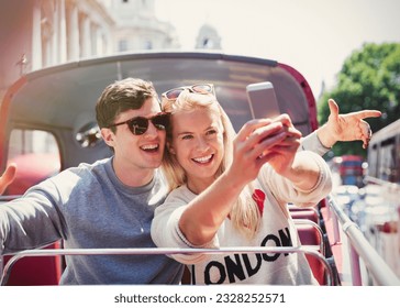 Couple taking selfie on double-decker bus in london - Powered by Shutterstock