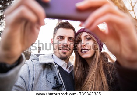 couple taking selfie in the street